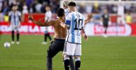 Lionel Messi tried to sign a pitch invader's bare back after 90th Argentina goal